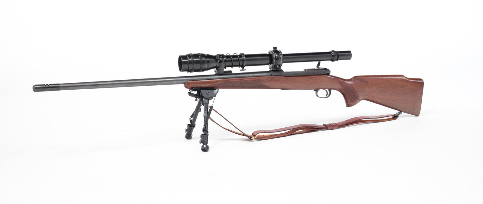 WINCHESTER MODEL 70 BOLT ACTION RIFLE WITH SCOPE: Winchester Model 70 .243 caliber bolt action rifle. Walnut stock with checkered grip and fore-end. 26" barrel, 49" overall. Includes a Bausch & Lomb BALvar 24 Target mounted scope and bipod. Serial nu
