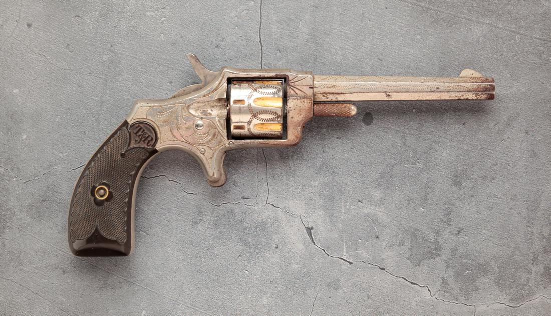 T&R CZAR .22 RIMFIRE SEVEN SHOT REVOLVER: T&R Czar .22 rimfire seven shot revolver. Checkered T&R plastic grips with engraved steel frame, barrel and fluted cylinder. 3-12" barrel length, 7" overall. Serial number 6686.