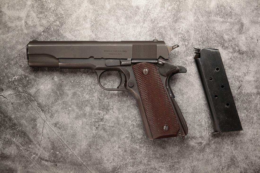 ITHACA GUN CO. MODEL 1911 A1 .45 SEMI AUTO PISTOL: Ithaca Gun Co. model 1911 A1 .45 caliber semi automatic pistol. Manufactured in 1945. "P" proof in front of rear sight. Left side of slide with "ITHACA GUN CO., INC / ITHACA, N.Y.". Frame with Ithaca