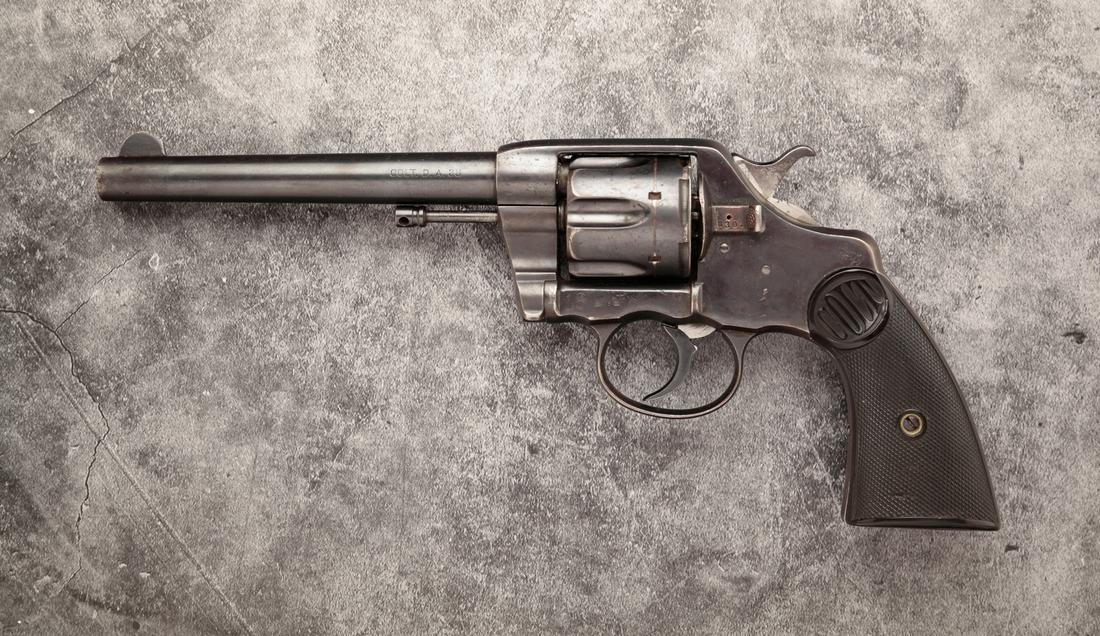 COLT NAVY .38 CALIBER DOUBLE ACTION REVOLVER: Colt Navy .38 caliber double action revolver. Checkered plastic grips with blued steel frame, cylinder and fluted barrel. 6" barrel length, 11-1/4" overall. Serial number 830.