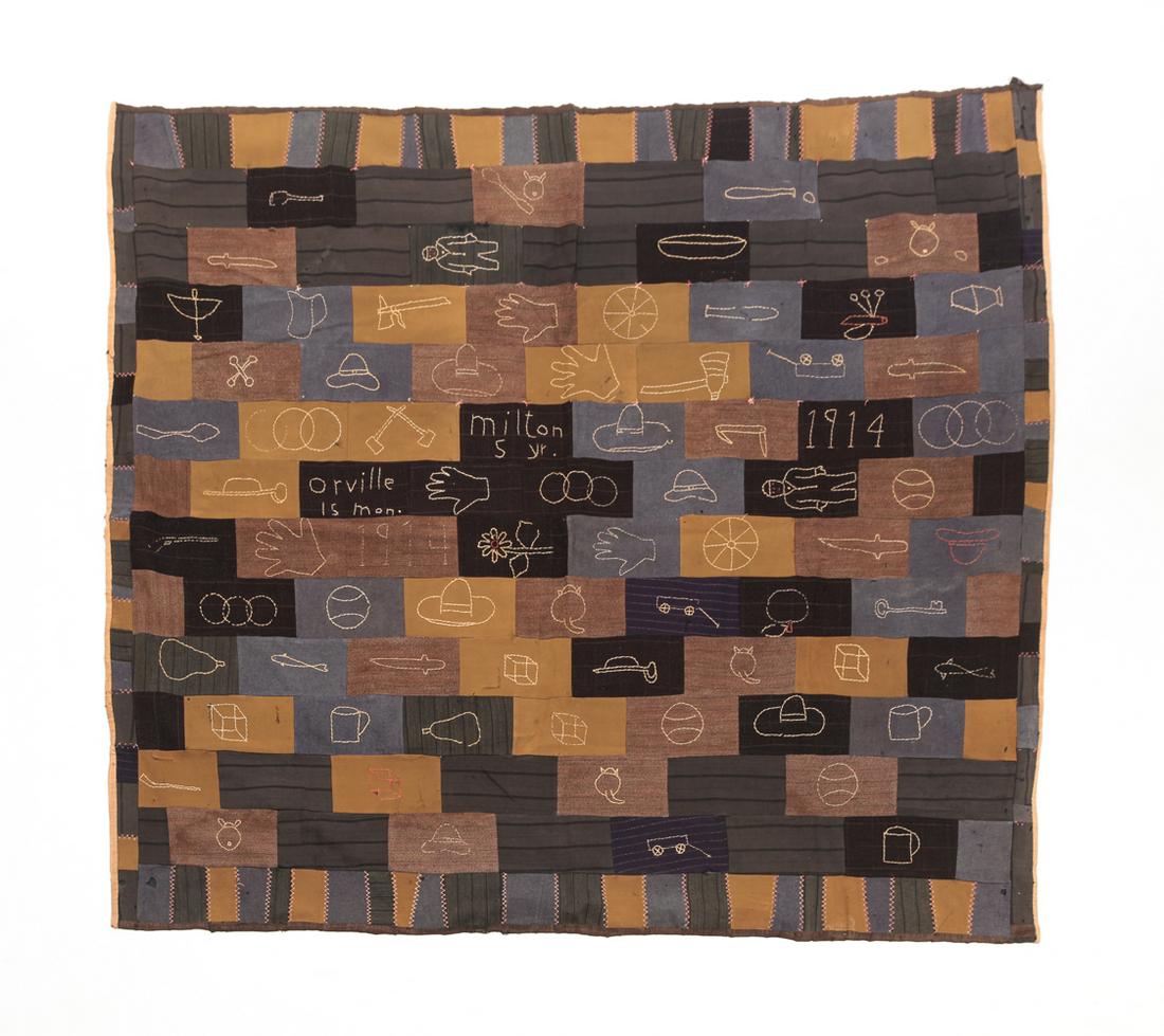FOLKSY PIECED QUILT.: Dated 1914. Pieced quilt in dark colors. Embroidered designs including fish, bow and arrow, and rifle. Embroidered "Milton 5 yr., Orville 15 mon." Wear, repairs and loss. From the collection of Ada an