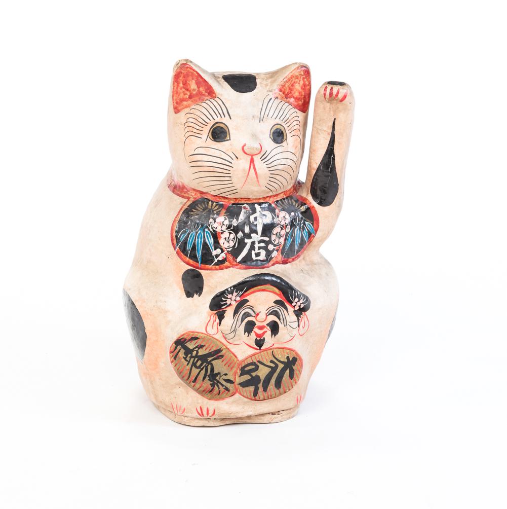 JAPANESE LUCKY CAT FIGURE.: Mid 20th century, papier mache. Seated cat with original paint. Minor wear, raised arm has indentation with crazing. 15.5"h.