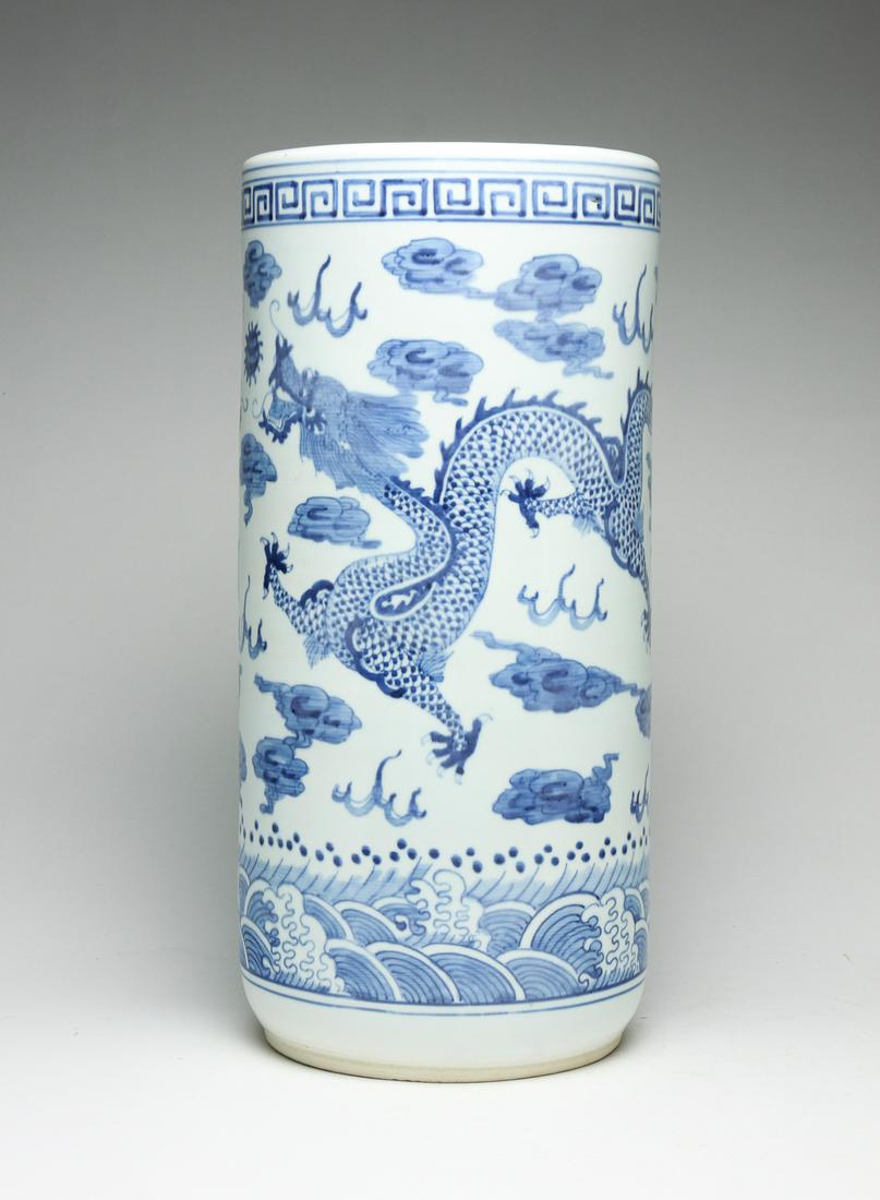 CHINESE PORCELAIN UMBRELLA STAND.: Twentieth century. Hand decorated with blue dragons. 18"h. 8.5"d.