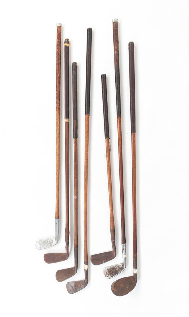SIX VINTAGE AMERICAN GOLF CLUBS.: Ca. 1920s-30s. Mostly putters with wood shafts and leather wrapped handles. Several are marked "MacGregor, Dayton, O". Varying wear and minor loss. Average 42"l.