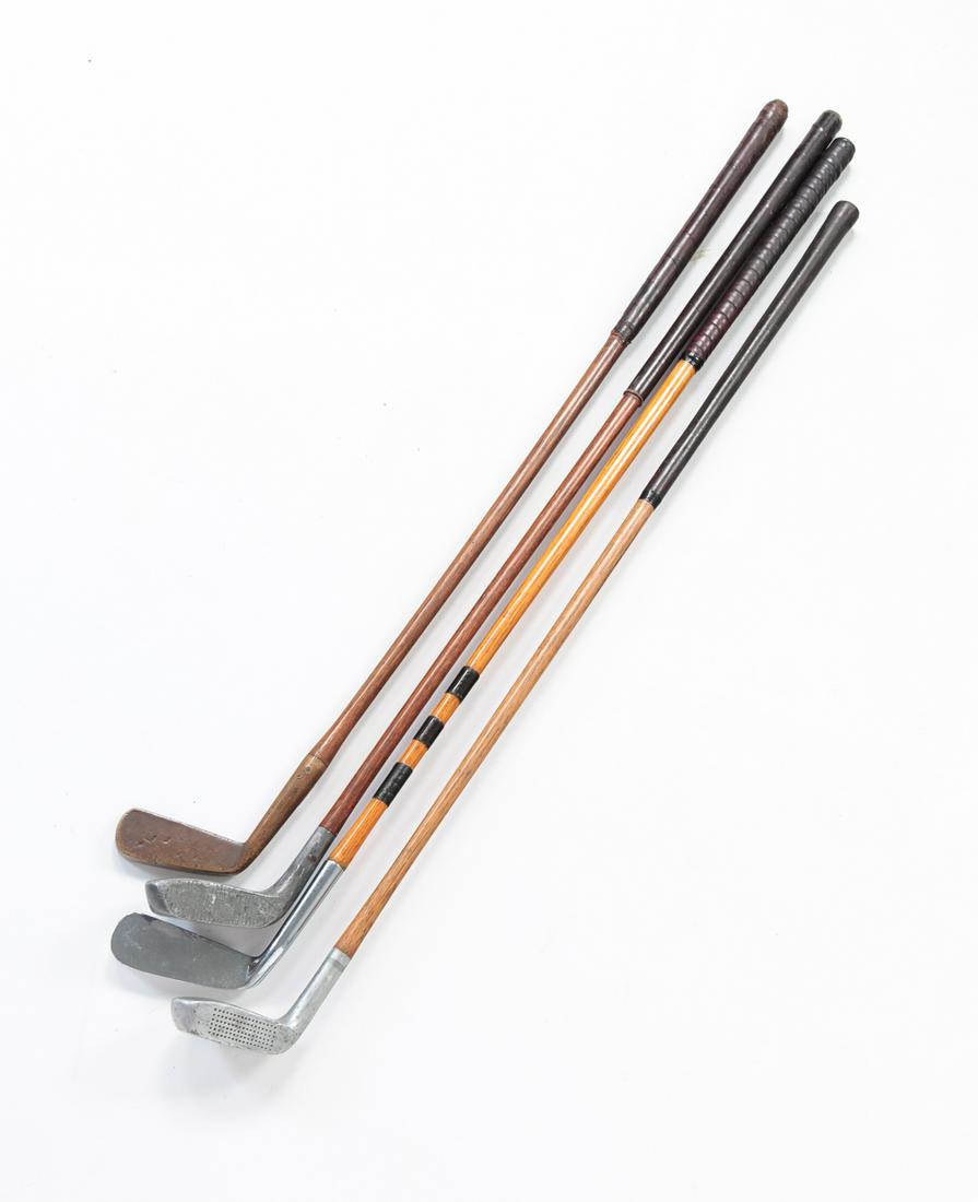 FOUR VINTAGE GOLF CLUBS.: American, ca. 1920s-30s. Wood shafts and leather grips. One brass head marked "T. Smith, Marietta, O." Others are "Braid Mills", "Spaulding" and "Custom Forged Calamity Jane". Minor wear. Average 35"l