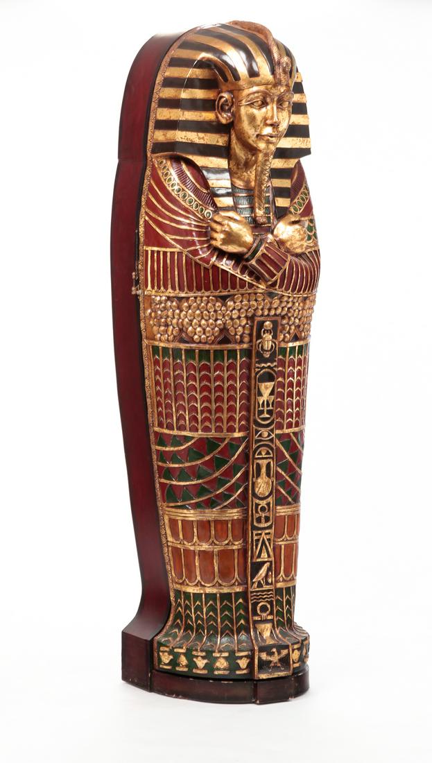 EGYPTIAN STYLE SARCOPHAGUS CABINET.: late 20th century, wood and resin. Painted sarcophagus with hinged front and removable interior shelves (one missing). Some surface wear. 75"h. 20.5"w. 20"d.