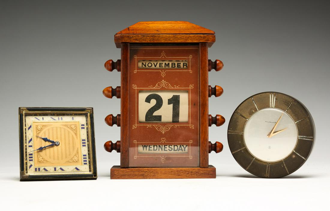 TWO TRAVELING ALARM CLOCKS AND PERPETUAL CALENDAR. (1 of 5)
