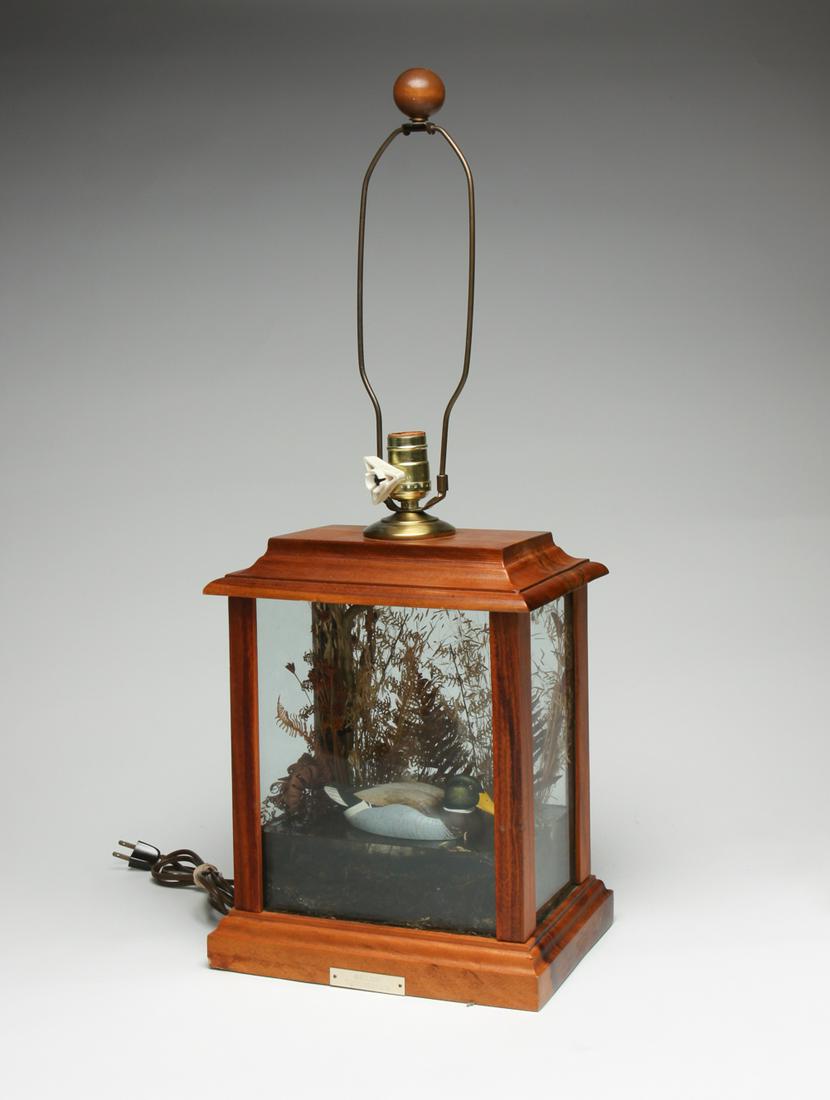 E. CULBERTSON DIORAMA TABLE LAMP.: Late 20th century. Mahogany frame with mallard floating on a body of water. With foliage in background and underwater vegetation. 29"h. 11"w. 7"d.