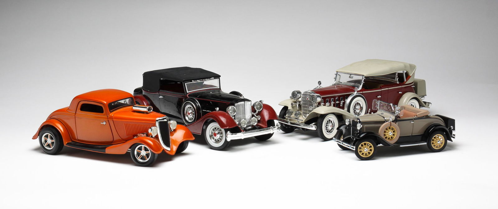 FOUR DIECAST CARS.: Late 20th century, made in China. Ford hot rod 9"l., 1931 Ford Model H, 6.75"l., 1934 Packard, 12"I. and a 1932 Cadillac, 11.5"l.