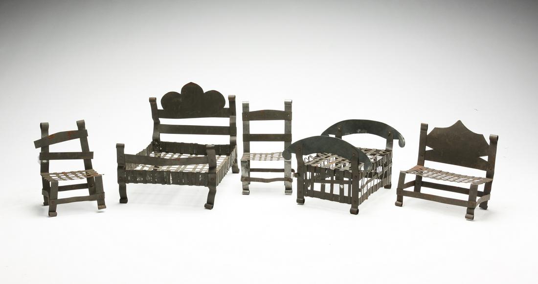 FIVE PIECES OF TIN DOLL FURNITURE.: American, early 20th century. Woven and cut out strips of tin. Two beds, largest, 6"h. 8.5"l., bench and two chairs. Some wear.