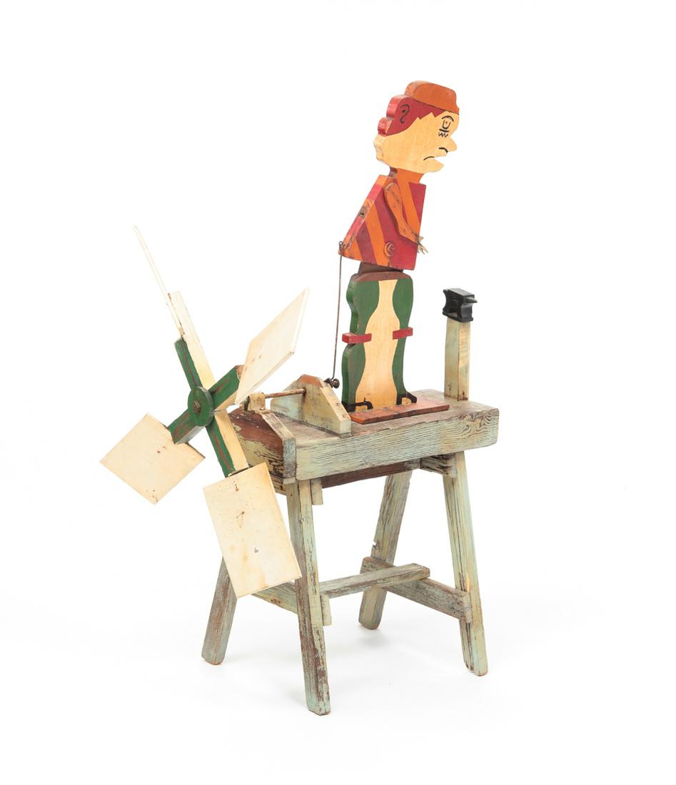 AMERICAN FOLK ART WHIRLIGIG.: Second quarter 20th century. Wooden cut out with original paint of a blacksmith and anvil. Some loss and glued repair. 31"h. 18.5"l.