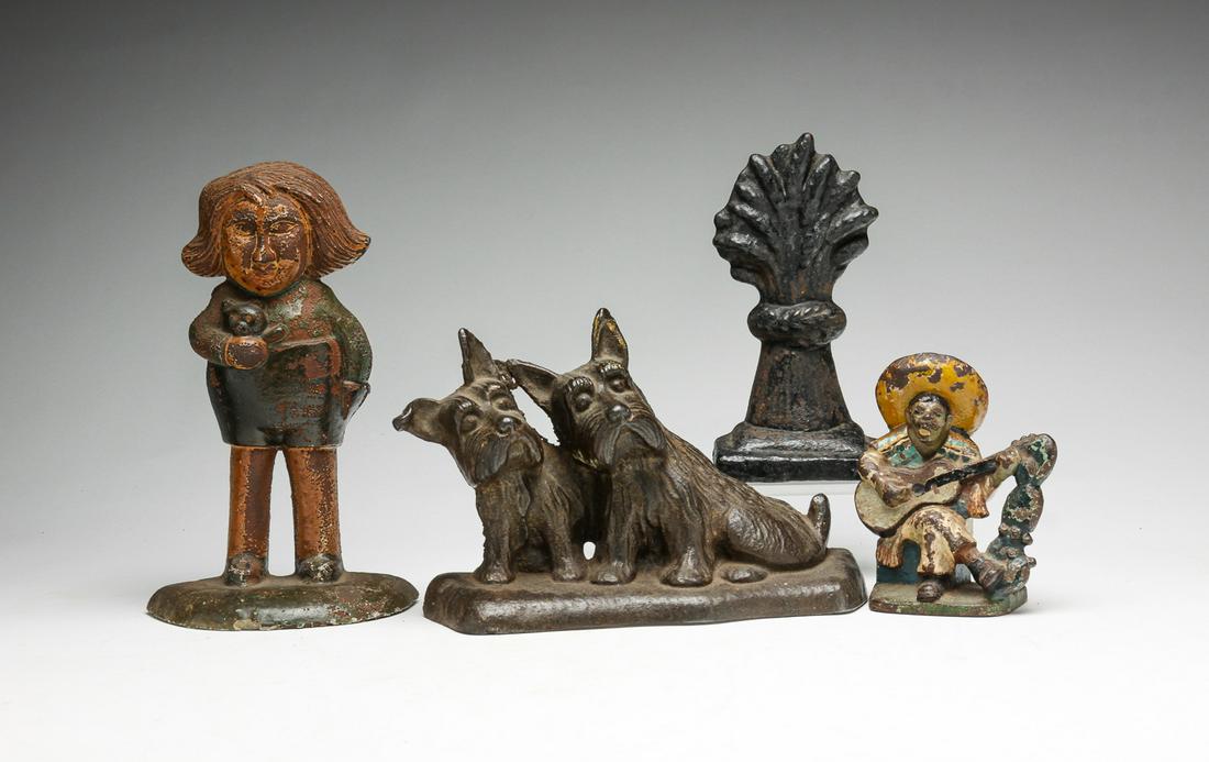 FOUR AMERICAN CAST IRON DOORSTOPS. (1 of 6)