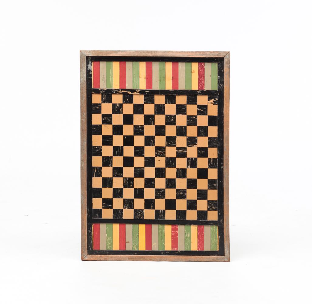 AMERICAN LINOLEUM GAMEBOARD.: Second quarter 20th century. Checkerboard with cut out pieces of linoleum including gallery ends. Wooden frame has traces of original silver paint. 19.75" x 28".