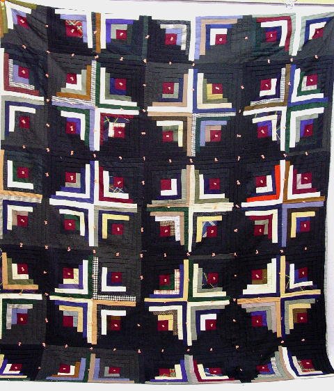 OHIO AMISH PIECED QUILT. Log cabin in su: OHIO AMISH PIECED QUILT. Log cabin in sunshine and shadow. Varying fabrics in predominantly dark colors. Tied with pink yarn. Some edge wear. 78" x 8&'.