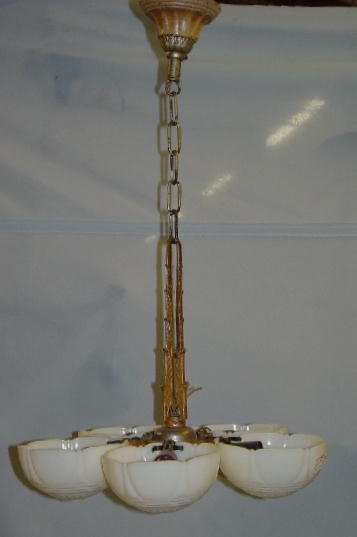 ART DECO CAST IRON HANGING LIGHT. Origin: ART DECO CAST IRON HANGING LIGHT. Original ochre paint. Five custard glass scalloped bowl shaped shades. Minor wear. 17"d. 28"h.