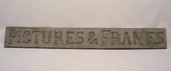LARGE CARVED WOODEN TRADE SIGN. Old grey paint wit: LARGE CARVED WOODEN TRADE SIGN. Old grey paint with stylish incised carved letters "Pictures & Frames". From Philadelphia. 10' 2"l. 15 1/2"h.