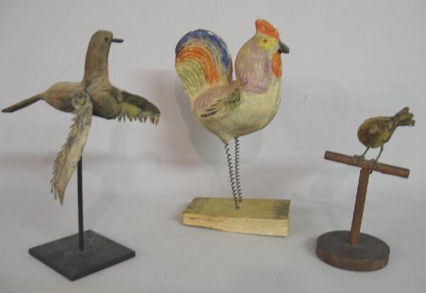 THREE BIRDS. Pictured is a rooster pipsqueak with: THREE BIRDS. Pictured is a rooster pipsqueak with bright original colors. Some damage and bellows are silent. 9 3/4"h. Also a primitive carved root bird with tin cutout wings (flaking paint on wings),