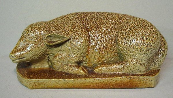 CURLY HAIRED STONEWARE LAMB. Molded reclining lamb