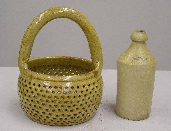 TWO PIECES OF STONEWARE. Bottle with impressed nam