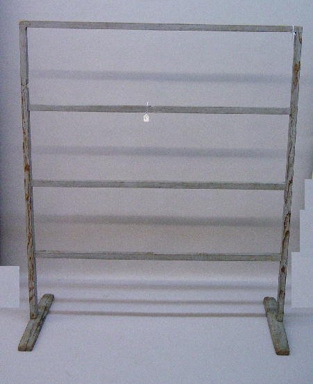 HERB DRYING RACK IN OLD BLUE GREY PAINT. Attribute: HERB DRYING RACK IN OLD BLUE GREY PAINT. Attributed to the Shakers. Mortise and peg construction with shoe feet, tapered uprights and four cross members. Stabilized split on one foot with square nails