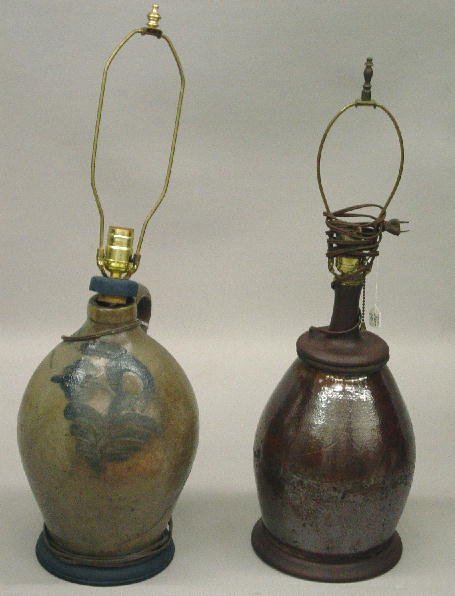 TWO EARLY POTTERY LAMPS. Both have later turned w: TWO EARLY POTTERY LAMPS. Both have later turned wooden fittings and electric sockets with brass harps. Redware ovoid jar with manganese glaze. Glaze flakes and pot stones. 26"h. Ohio stoneware jug wit