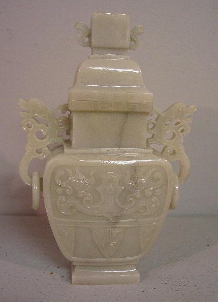 ORIENTAL CARVED VASE. Mutton fat nephrite jade cov: ORIENTAL CARVED VASE. Mutton fat nephrite jade covered vase with pierce carved dragon handles with rings. 7 1/2"h. Wooden base and fitted case included.