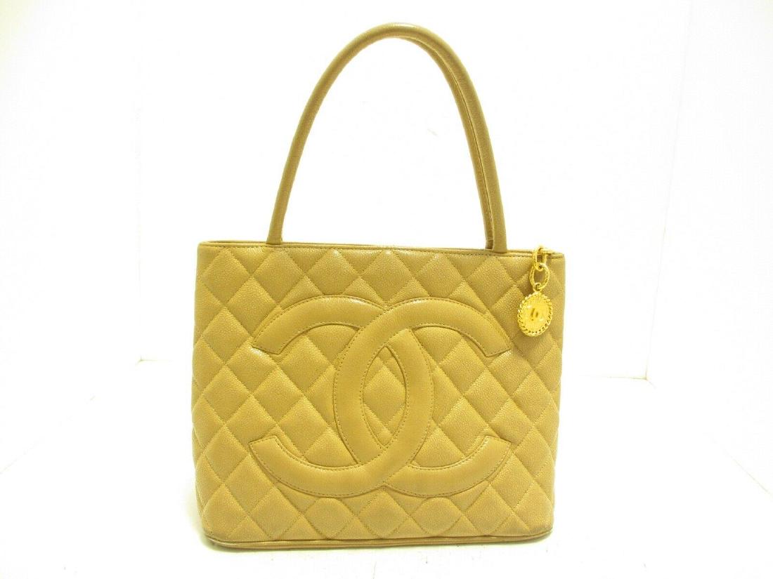 CHANEL TOTE BAG: Brand: CHANEL Style: Tote Bag Color: LightBrown Material: Caviar Skin Product Name: Caviar Medallion Tote Serial: Inside bag All Bidhaus items come with an Authenticity Guarantee. Unless specified abo