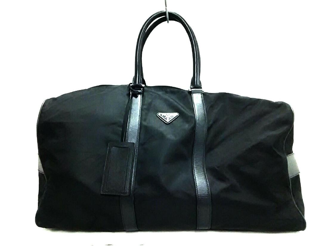 PRADA BOSTON BAG: Brand: PRADA Style: Boston Bag Color: Black Material: Nylon Leather Accessories: Name Tag, Dial Lock All Bidhaus items come with an Authenticity Guarantee. Unless specified above, item does not come w