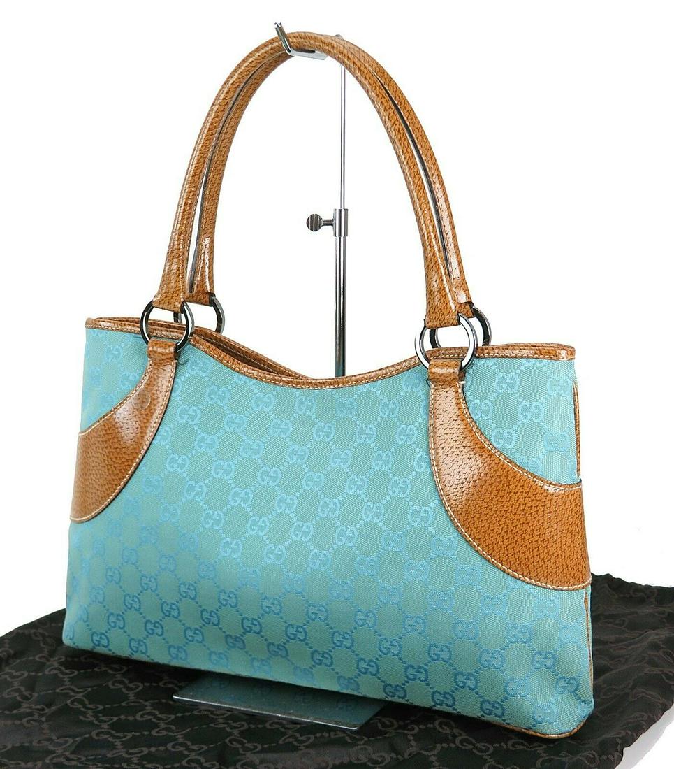 GUCCI Bluish Tote: Brand: Gucci Style: Totes & Shoppers Material: Canvas Color: Green Size: Width: 16.9 (bag top) Height: 10.6 Depth: 4.3 Country of Origin: Medium Comes With: All Bidhaus items come with a 100% money-ba