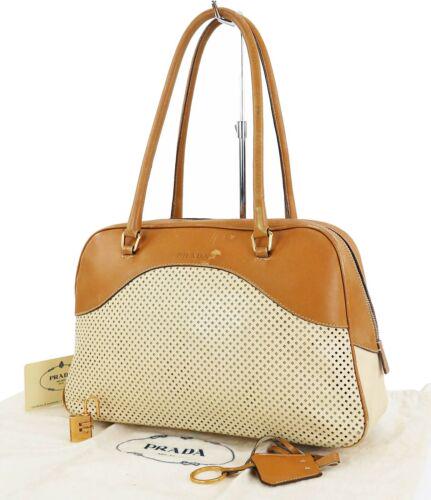 PRADA Perforated Tote: Brand: PRADA Style: Tote Material: Leather Color: Beige Size: Width: 12.5 Height: 7 Depth: 3.9 Country of Origin: Medium Comes With: All Bidhaus items come with a 100% money-back authenticity guarante