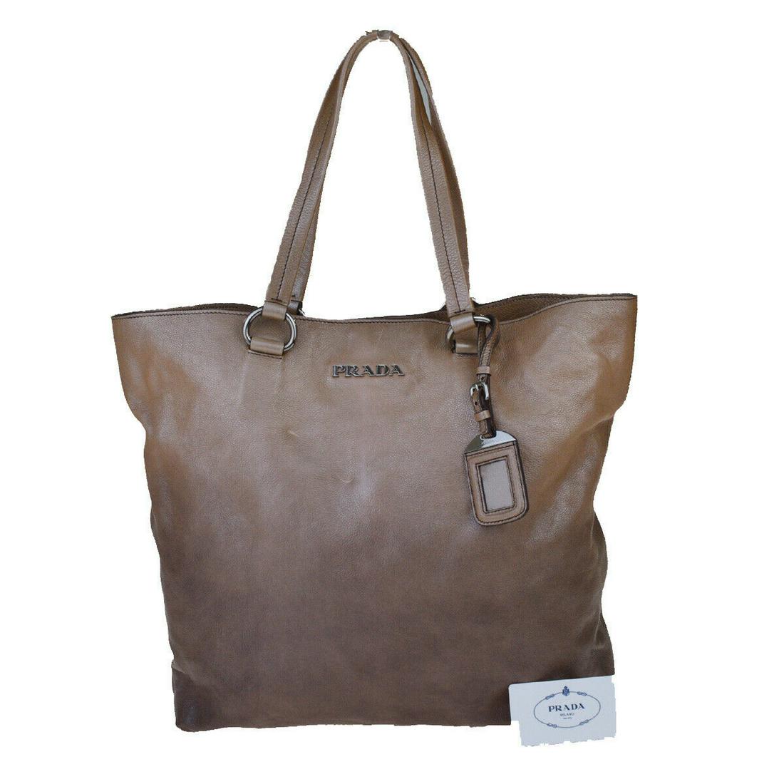 Authentic Prada Leather Shoulder Bag: Brand: PRADA Style: Shoulder Bag Material: Leather Color: Brown Size: Medium Size (Inches): W 13.4 x H 13.4 x D 4.3 "(approx.) Strap Drop: 7.5 Country of Origin: Italy Comes With: All Bidhaus items co