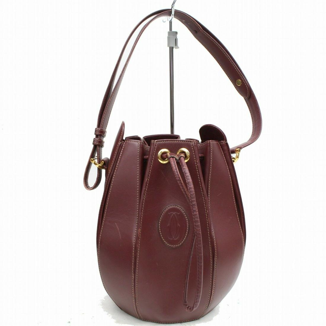 Authentic Cartier Leather Shoulder Bag: Brand: Cartier Style: Shoulder Bag Material: Leather Color: Bordeaux Size: Height: Depth: Width: Comes With: All Bidhaus items come with a 100% money-back authenticity guarantee. Please refer to image