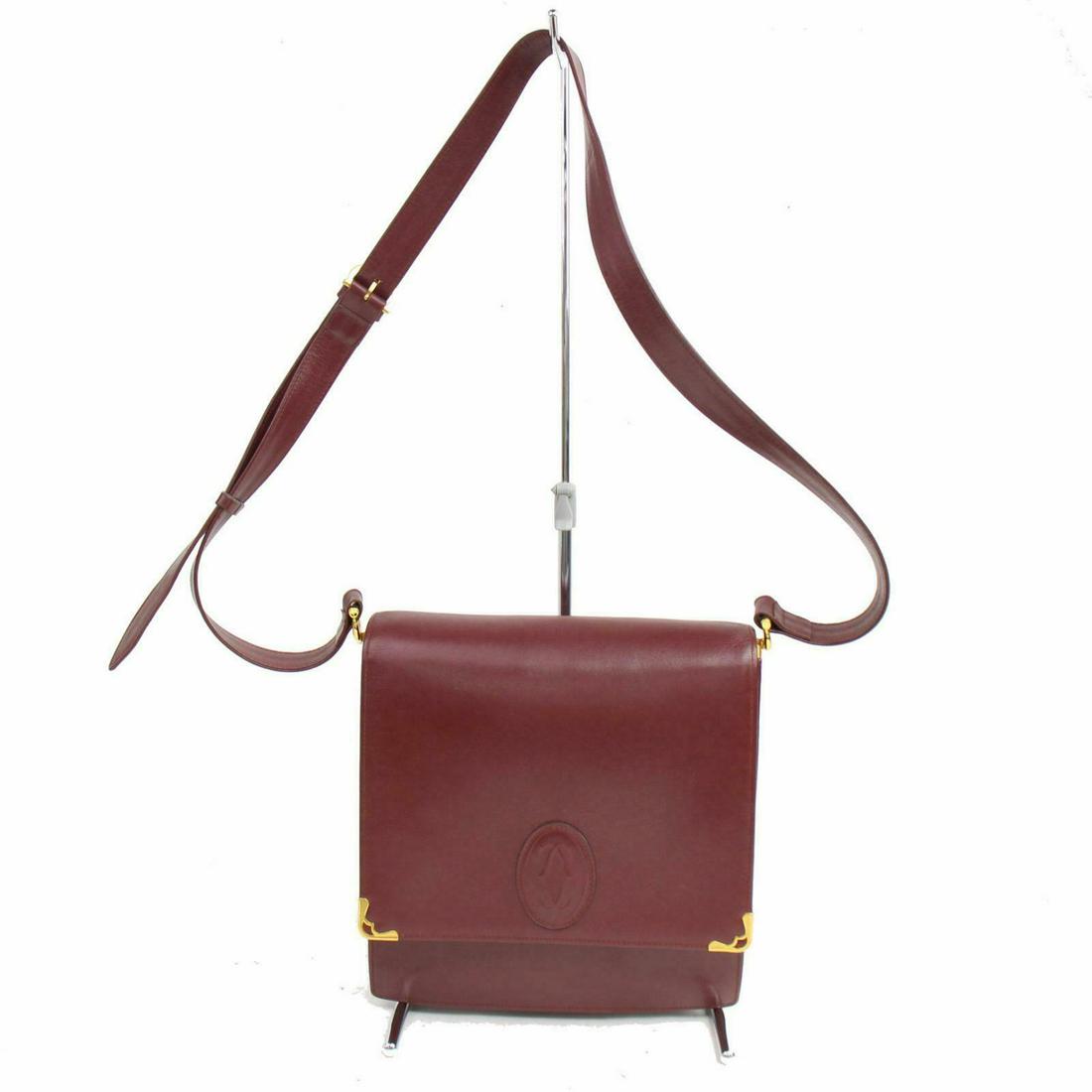 Authentic Cartier Leather Shoulder Bag: Brand: Cartier Style: Shoulder Bag Material: Leather Color: Bordeaux Size: Height: Depth: Width: Comes With: All Bidhaus items come with a 100% money-back authenticity guarantee. Please refer to image