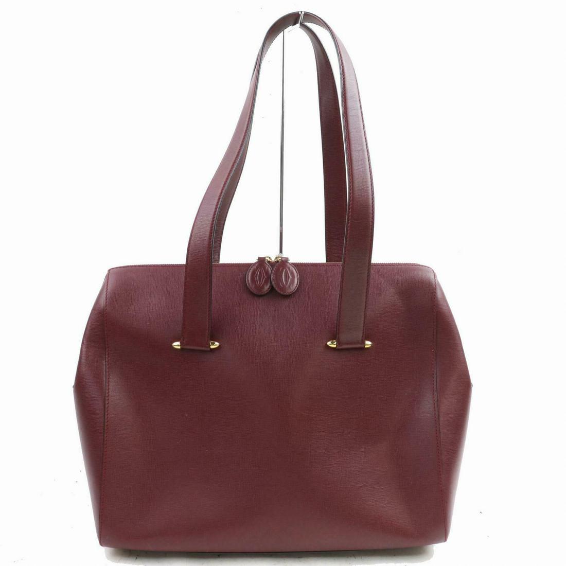 Authentic Cartier Leather Hand Bag: Brand: Cartier Style: Hand Bag Material: Leather Color: Bordeaux Size: Height: 11.0 inch(approx) /28 cm(approx) Depth: 4.72 inch(approx) /12 cm(approx) Width: 13.7 inch(approx) /35 cm(approx) Comes Wi