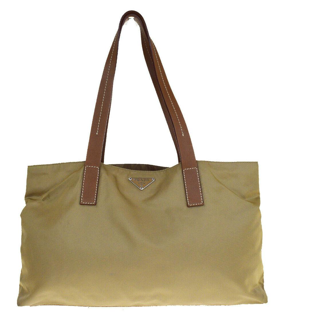 Authentic Prada Leather Nylon Shoulder Bag: Brand: PRADA Style: Shoulder Bag Material: Leather Nylon Color: Beige Size: Medium Size (Inches): W 14.2 x H 7.9 x D 3.9 "(approx.) Strap Drop: 9.8 Country of Origin: Italy Comes With: All Bidhaus ite