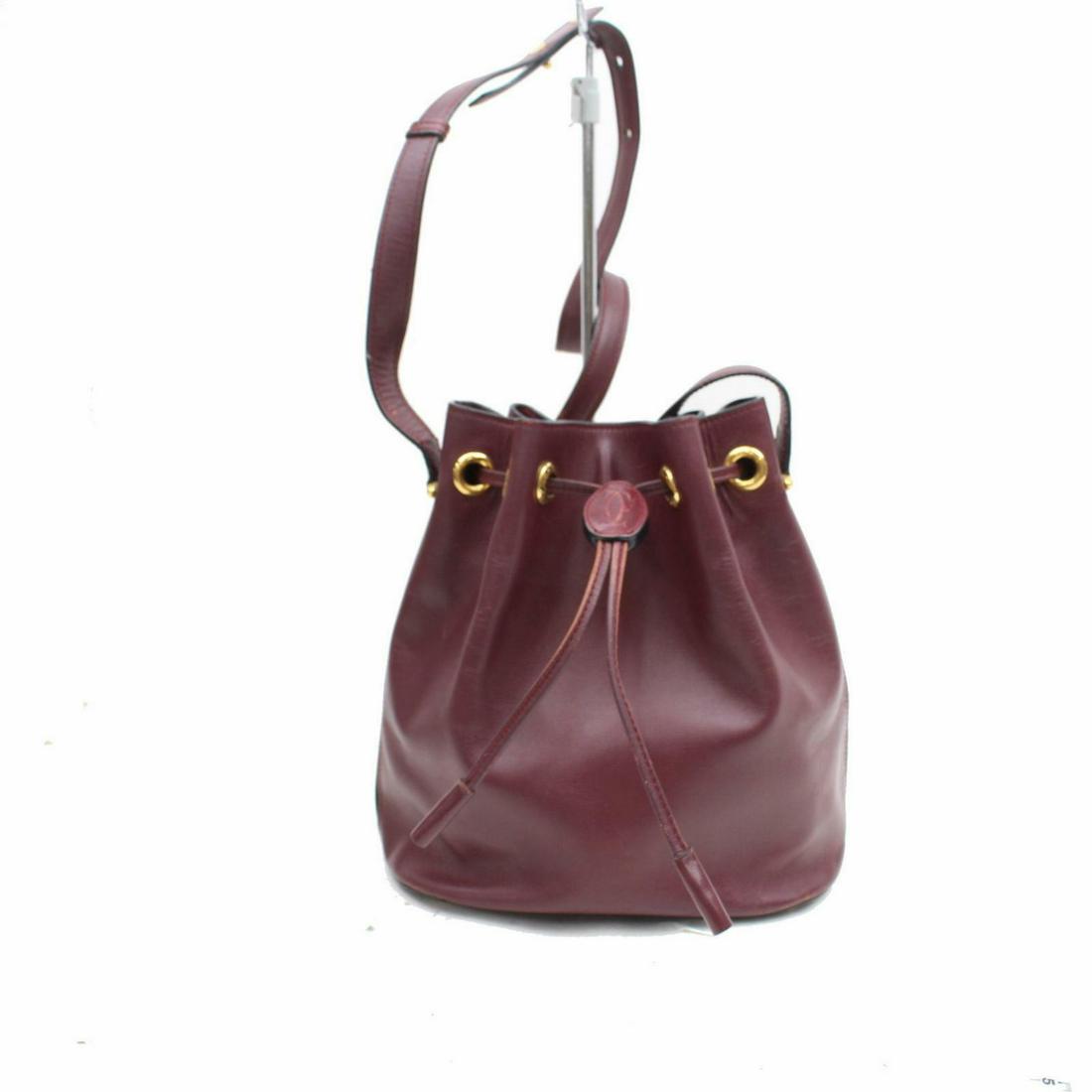 Authentic Cartier Leather Shoulder Bag: Brand: Cartier Style: Shoulder Bag Material: Leather Color: Bordeaux Size: Height: Depth: Width: Comes With: All Bidhaus items come with a 100% money-back authenticity guarantee. Please refer to image