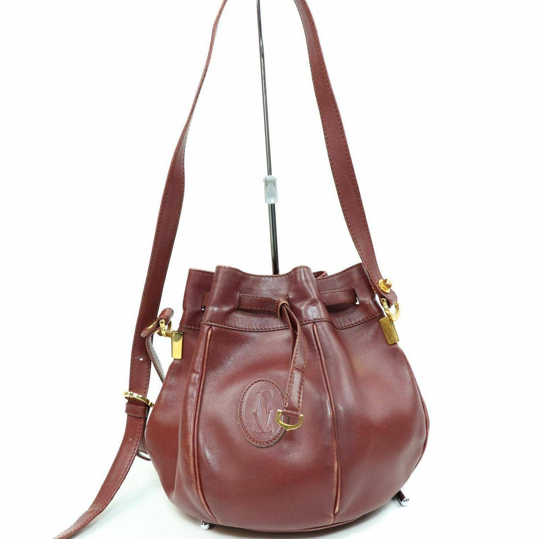 Authentic Cartier Leather Shoulder Bag: Brand: Cartier Style: Shoulder Bag Material: Leather Color: Bordeaux Size: Height: Depth: Width: Comes With: All Bidhaus items come with a 100% money-back authenticity guarantee. Please refer to image