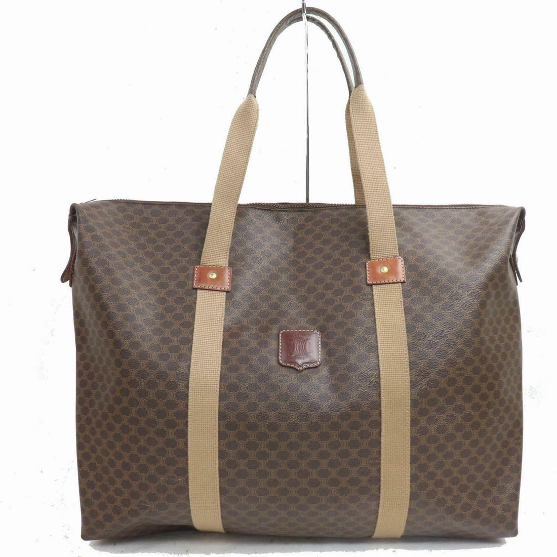 Authentic Celine Travel Bag: Brand: CELINE Style: Travel Bag Material: PVC Color: Browns Size: Height: 14.1 inch(approx) /36 cm(approx) Depth: 5.90 inch(approx) /15 cm(approx) Width: 17.7 inch(approx) /45 cm(approx) Comes With: A