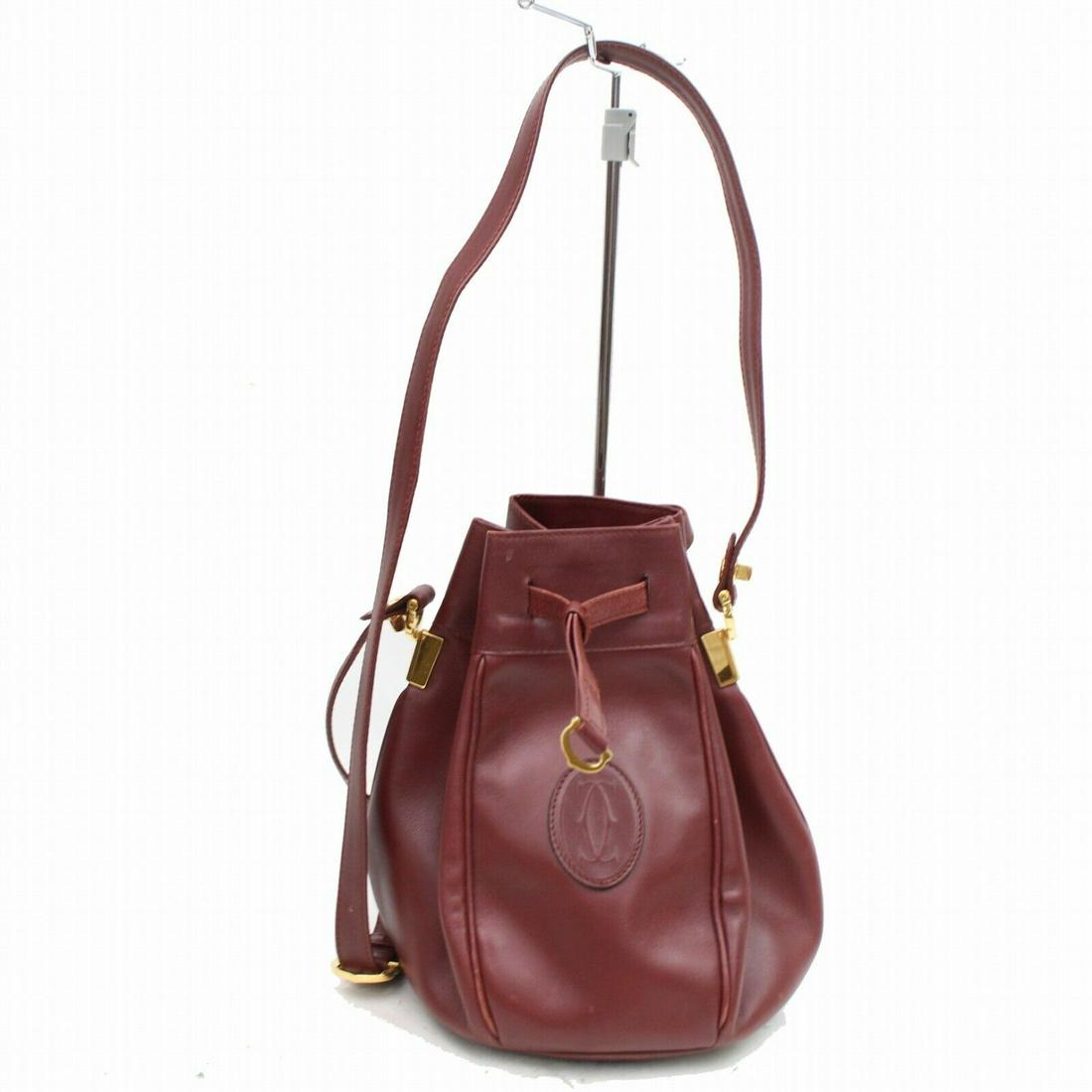 Authentic Cartier Leather Shoulder Bag: Brand: Cartier Style: Shoulder Bag Material: Leather Color: Bordeaux Size: Height: Depth: Width: Comes With: All Bidhaus items come with a 100% money-back authenticity guarantee. Please refer to image