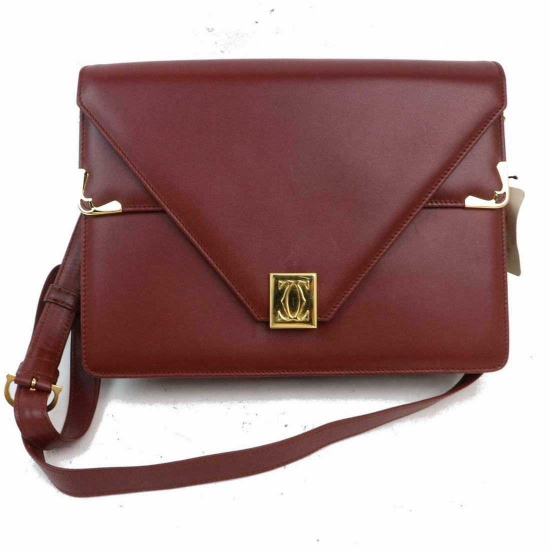Authentic Cartier Leather Shoulder Bag: Brand: Cartier Style: Shoulder Bag Material: Leather Color: Bordeaux Size: Height: 6.69 inch(approx) /17 cm(approx) Depth: 1.96 inch(approx) /5 cm(approx) Width: 9.44 inch(approx) /24 cm(approx) Comes