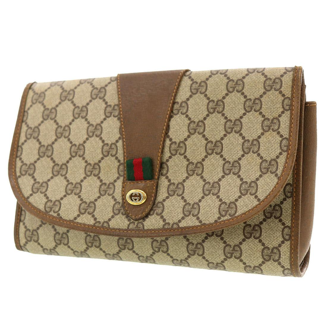 Authentic Brown Gucci Clutch: Brand: Gucci Style: Clutch Material: PVCÂ Leather Color: Brown Size (Inches): H 6.2 Â x D 2.7 Â x L 9.8 Comes With: Outside : - Inside : Button Pocket All Bidhaus items come with a 100% money-ba