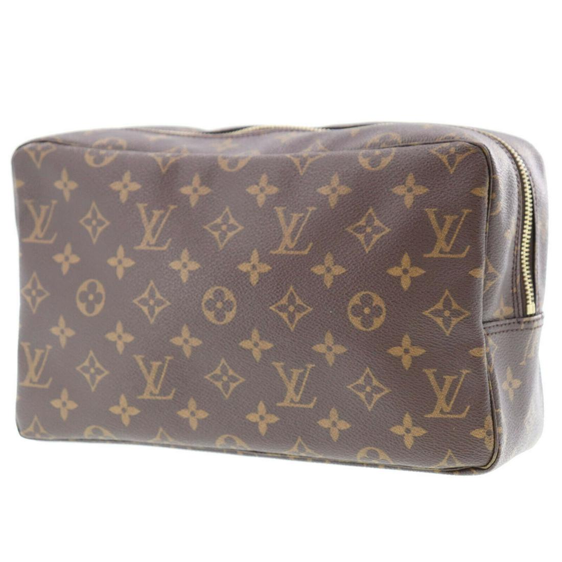 Authentic Brown Louis Vuitton Clutch Bag: Brand: Louis Vuitton Style: Clutch Bag Color: Brown Material: Monogram Canvas Leather Size (Inches): H 6.6 Â x D 3.1 Â x L 11.0 Comes With: - All Bidhaus items come with a 100% money-back authenti
