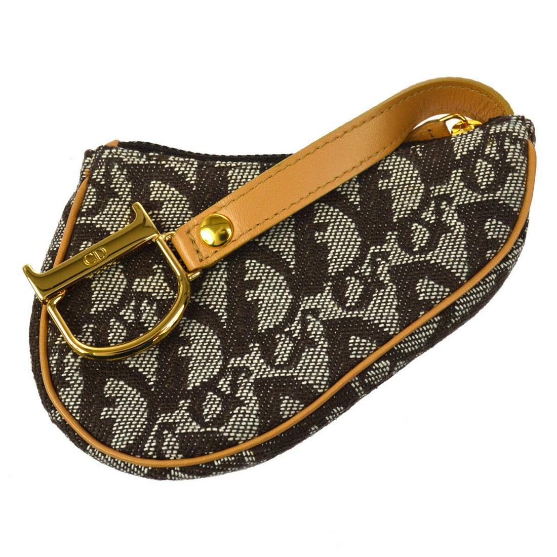 Authentic Christian Dior Trotter Saddle Mini Pouch: Brand: Christian Dior Material: Canvas, Leather Style: Pouch Color: Brown Size(inch): W4.7 x H3.3 x D0.8 " Country of Origin: Italy Come with: - All Bidhaus items come with a 100% money-back authentic