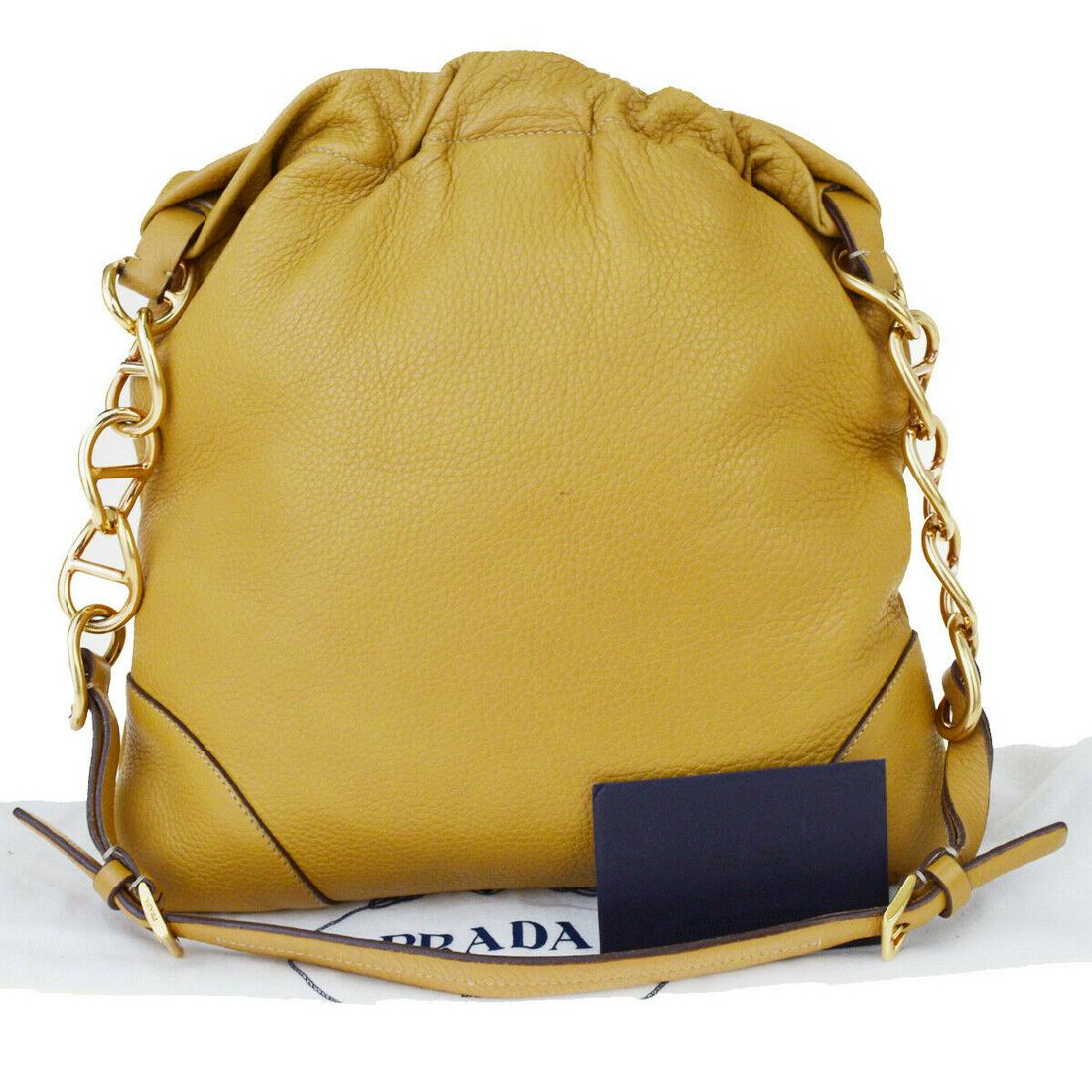 Authentic PRADA Shoulder bag: Brand: PRADA Material: Leather Style: Shoulder bag Color: Beige Size(inch): W 11.4 x H 11 x D 0.8 "(approx.) Country of Origin: Italy Come with: Dust bag,Authenticity Card All Bidhaus items come with 