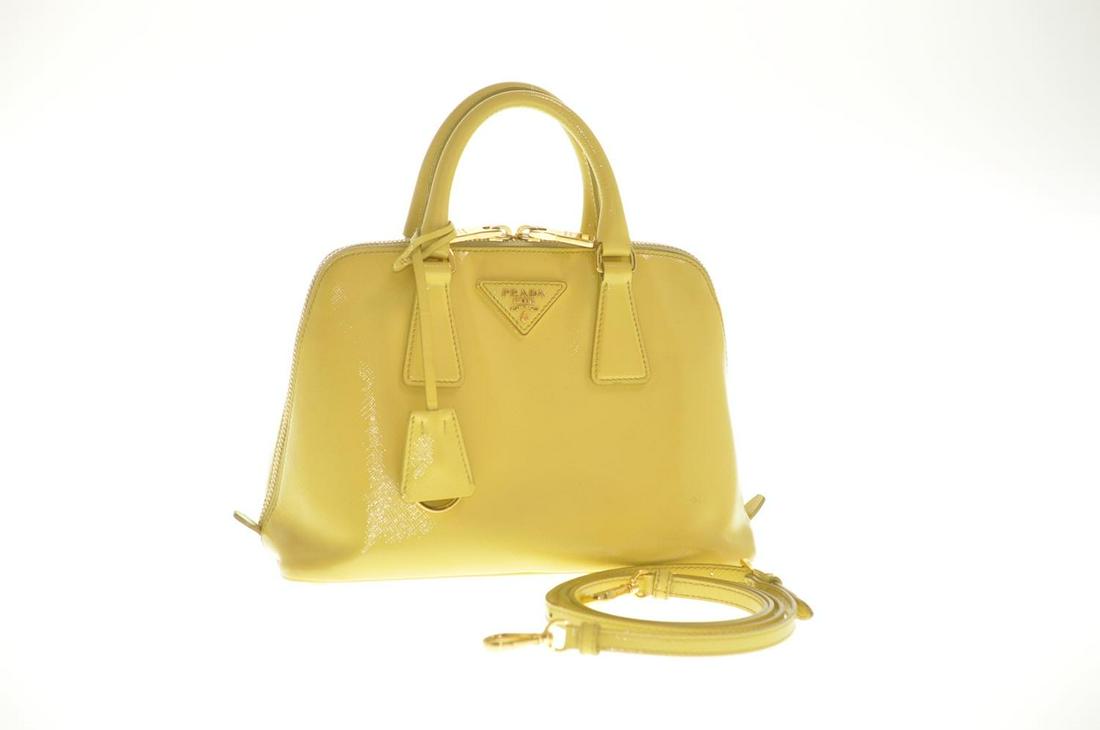 Authentic Prada Sapphire Leather 2Way Hand Bag: Brand: Prada Style: Hand Bag Material: Leather Color: Yellow Size (Inches): W9.44 X H6.69 X D3.93" / Shoulder Drop 21.25-24.4"(Approx) Exterior Condition: Leather : Minor Rubbing, Signs Of Age Strap :