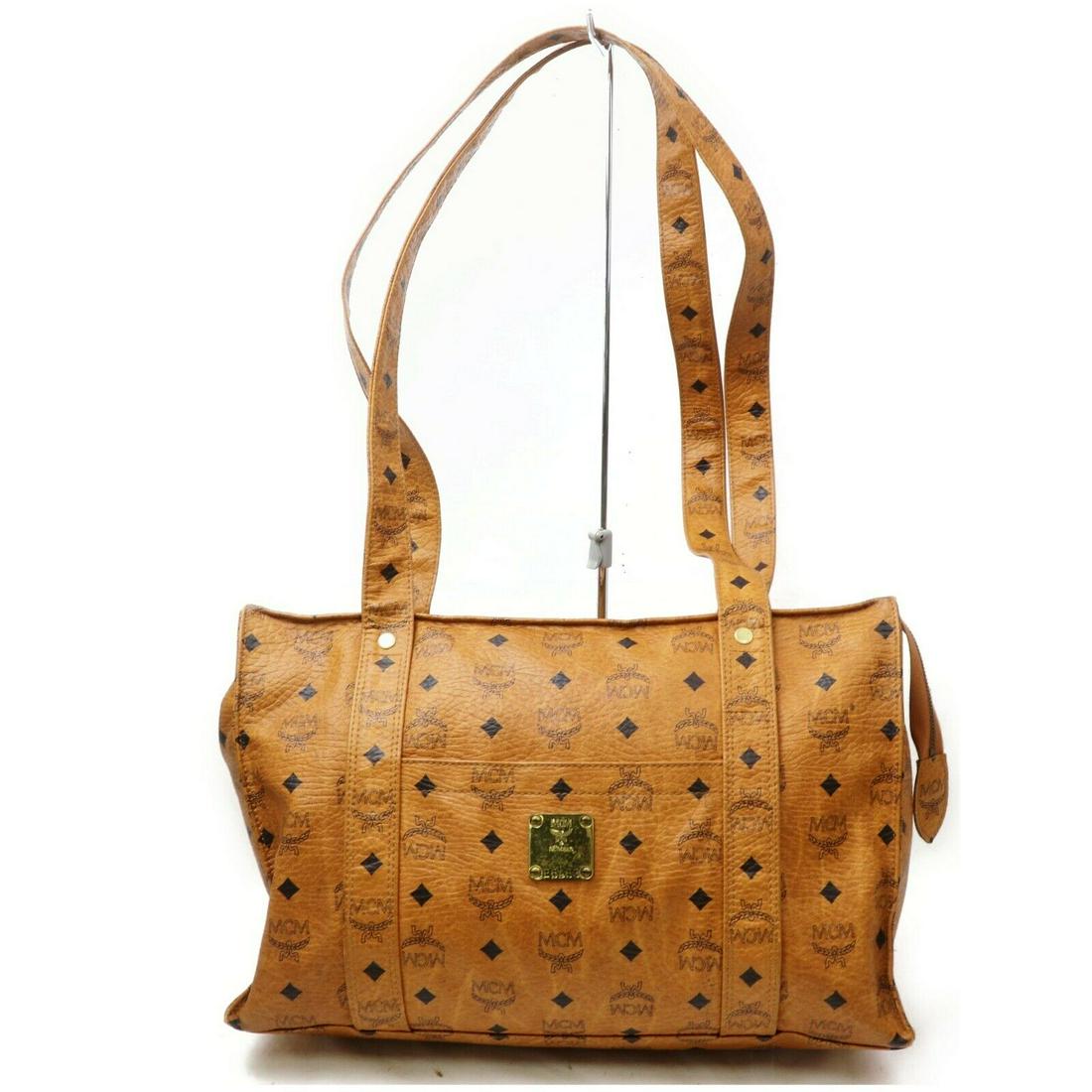 Authentic MCM Tote Bag: Brand: MCM Material: PVC Style: Tote Bag Color: Browns Size(inch): W14.9 inch(approx) /38 cm(approx) x H10.2 inch(approx) /26 cm(approx) x D5.90 inch(approx) /15 cm(approx) " / Strap Drop: Shoulder (i