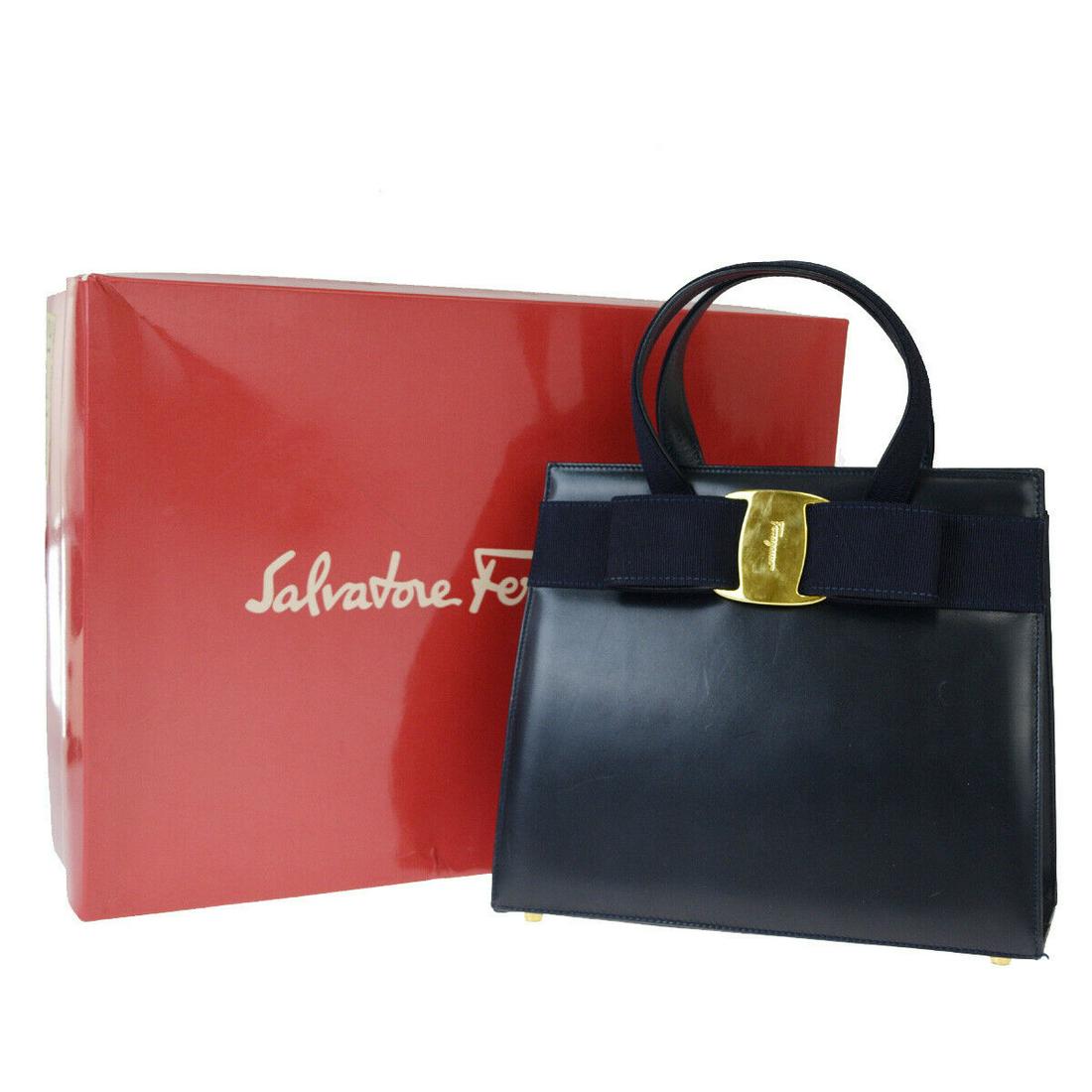Authentic SALVATORE FERRAGAMO Leather/Canvas Hand Bag: Brand: SALVATORE FERRAGAMO Material: Leather, Canvas Style: Hand Bag Color: Navy Blue Size(inch): W 9.4 x H 7.9 x D 3.9 "(approx.) Country of Origin: Italy Come with: Box All Bidhaus items come with a