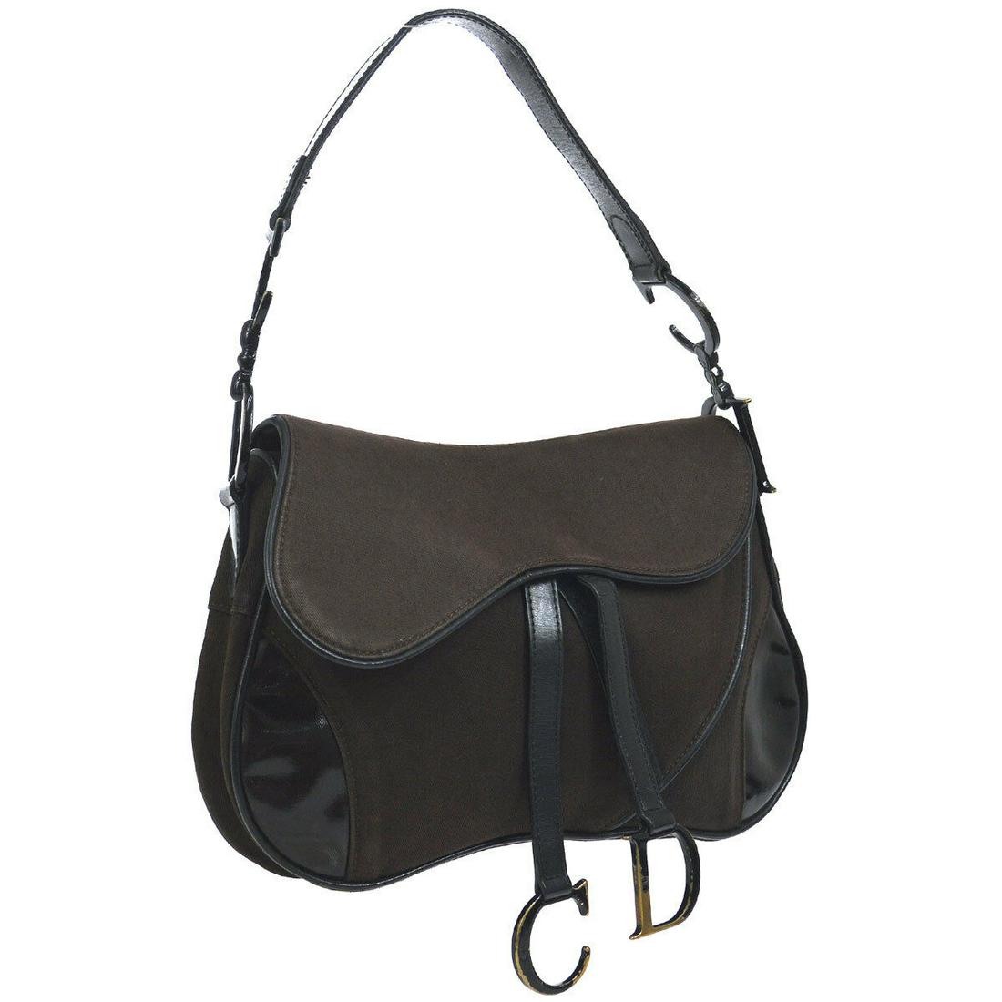 Authentic CHRISTIAN DIOR Trotter Saddle Hand Bag: Brand: CHRISTIAN DIOR Material: Canvas, Coated Canvas, Leather Style: Hand Bag Color: Brown Size(inch): W11.0 x H6.7 x D2.4 " Country of Origin: Italy Come with: - All Bidhaus items come with a 100% m