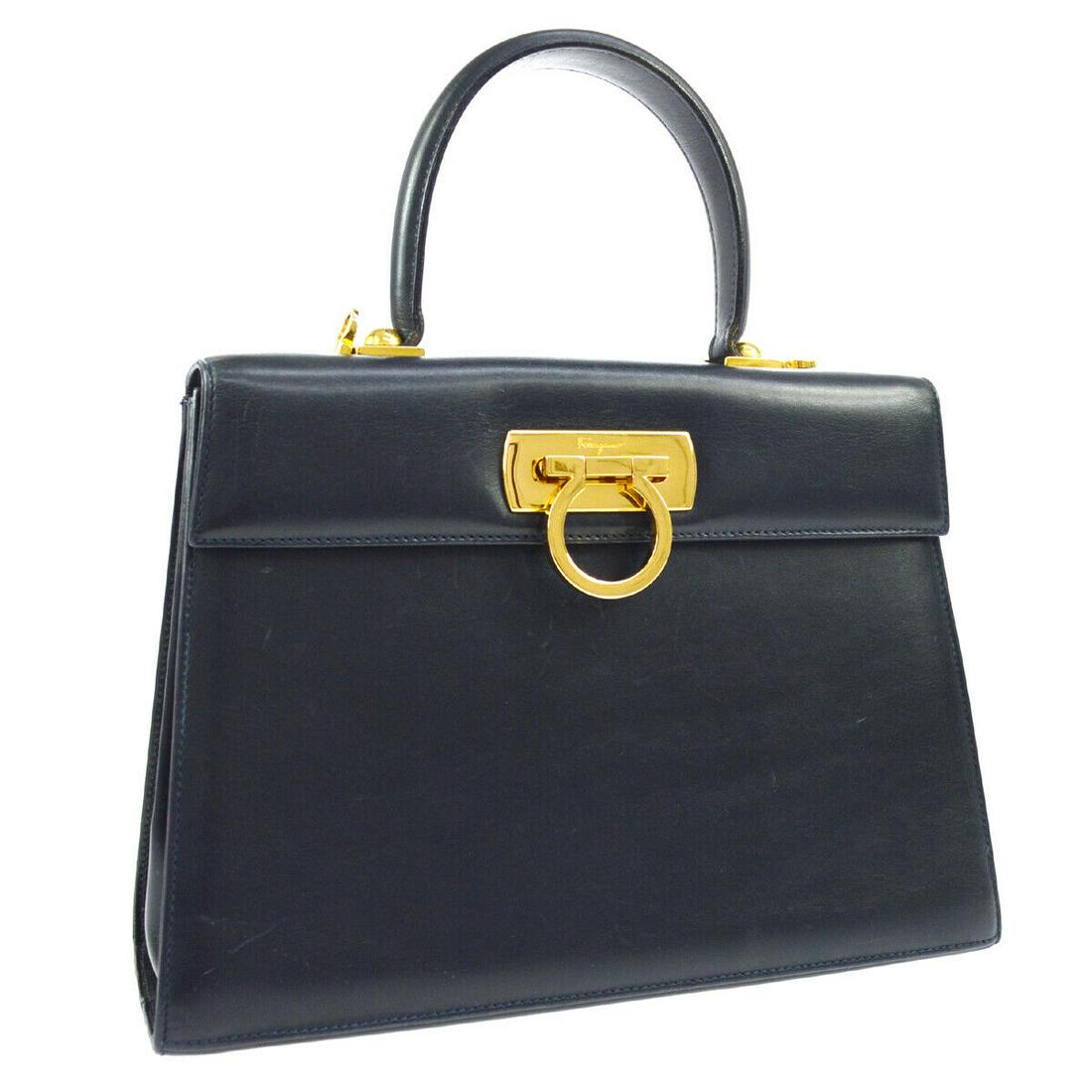 Authentic SALVATORE FERRAGAMO Gancini 2way Hand Bag: Brand: SALVATORE FERRAGAMO Material: Leather Style: Handbag Color: Navy Size(inch): W10.2 x H8.3 x D3.9 " / Strap Drop: 18.1 - 19.7 Country of Origin: Italy Come with: Shoulder strap, Dust Bag All Bid