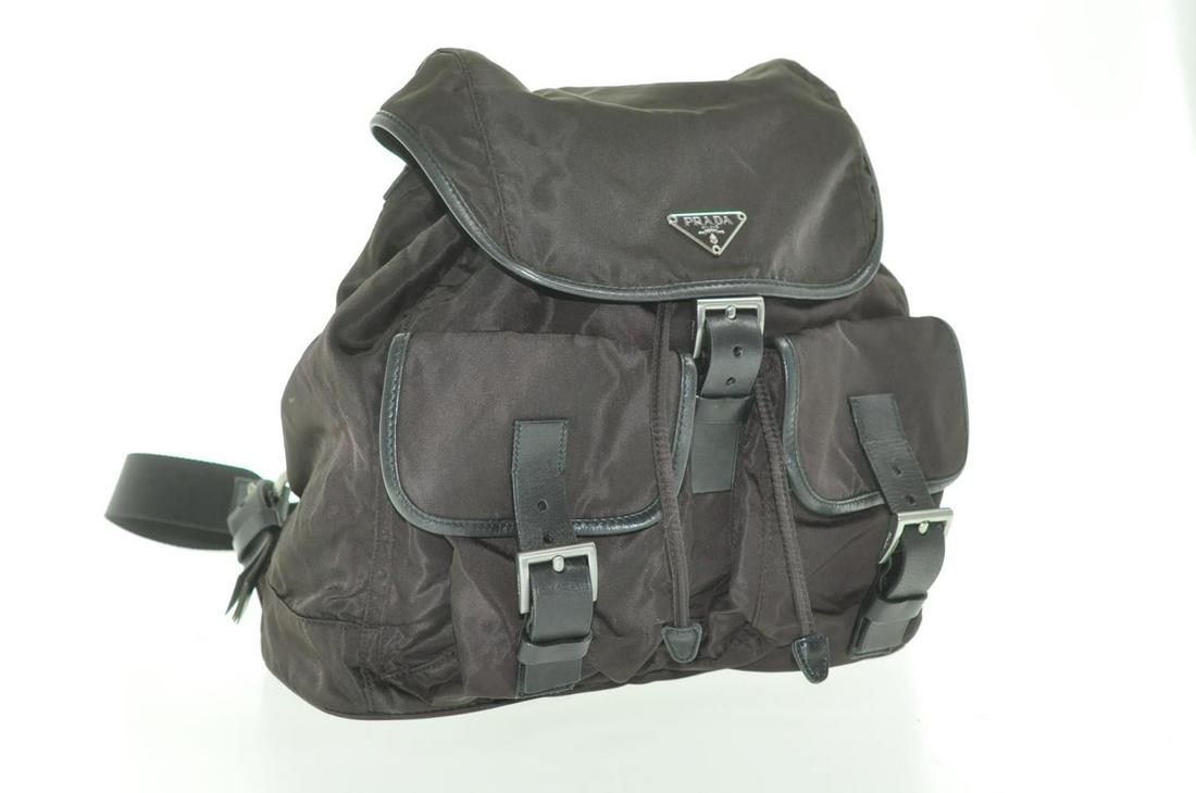 Authentic PRADA Nylon Backpack: Brand: PRADA Material: Nylon Style: Backpack / Knapsack Color: Dark Brown Size(inch): W10.62 x H10.62 x D5.51 / Shoulder Drop 13.38-14.56â€³(Approx) Country of Origin: Italy Accessory: Guarantee C